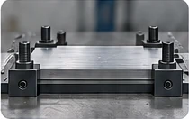 Aluminium plate held flat by machining clamps.