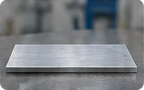Nearly flat aluminium blank before machining.